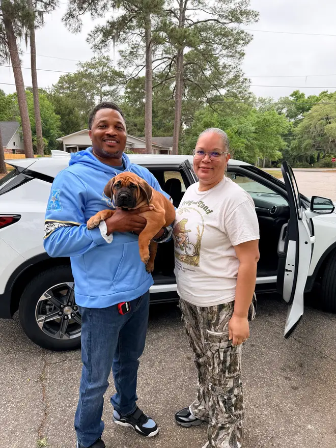 A couple on collection day with the South African Boerboel puppy they are taking home from LowCountry Boerboels
